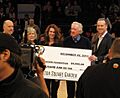 Jamie Dixon and family accepting a check
