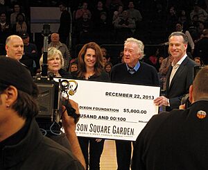 Jamie Dixon and family accepting a check