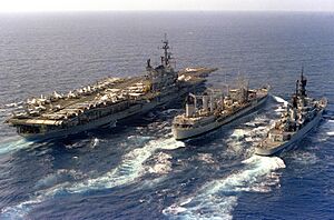 USNS Navasota (T-AO-106) refuels USS Midway (CV-41) and USS England (CG-22) on 7 December 1983 (6483143)