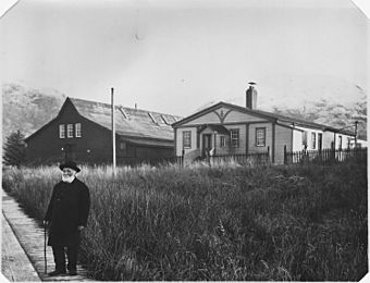 William Duncan, about 84 years old in front of his store (left) and residence (right). - NARA - 297899.jpg