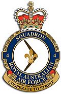 Crest of 4 Squadron, Royal Australian Air Force, featuring a fleur-de-lis on a boomerang and the motto "Cooperate to Strike"