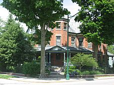 Grand old three-story brick house with porch