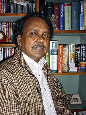 Portrait of a man standing in font of bookshelf