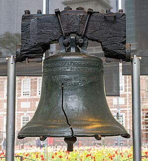a large bronze bell with a pronounced crack in it, hangs from a blackened wooden yoke. This is the Liberty Bell