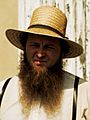 Amish Man in straw hat, suspenders, and shenandoah beard