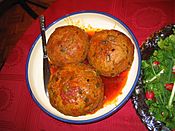 Three eight-inch meatballs in sauce