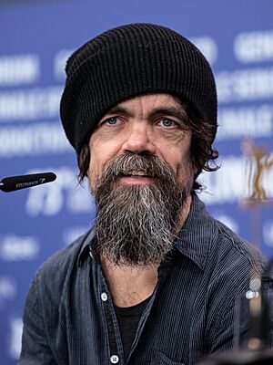 Dinklage speaking into a microphone