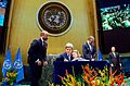 Secretary Kerry Holds Granddaughter Dobbs-Higginson on Lap While Signing COP21 Climate Change Agreement at UN General Assembly Hall in New York (26512345421)
