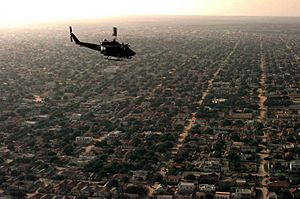 Aerial view of a US helicopter as it flies over a Mogadishu residential area