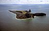 Aerial view of irregularly-shaped island with prominent rocky outcroppings