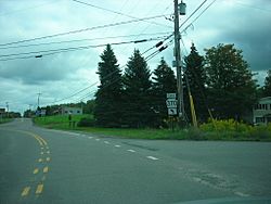 Image of a paved, marked road, flanked by greenery on both sides. A sign in the center of the photo reads "EAST 370."