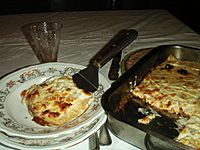 Lasagne al forno servite nel piatto con la paletta