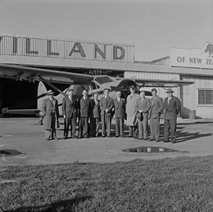 Sir Edmund Hillary and others in front of an airplane at Rongotai Airport, Wellington
