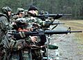 US Navy 060408-N-2296G-003 Personnel from the Army, Navy and Washington State National Guard conducts a weapons qualification exercise on a cold and rainy day at Fort Lewis, Wash