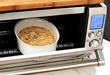 Crab dip being baked in a toaster oven
