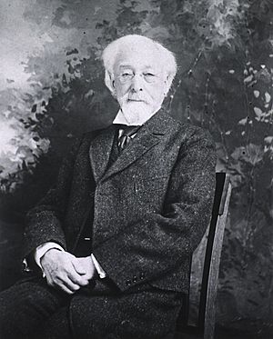 Three-quarter length, seated in chair, front pose, tweed suit, very old man