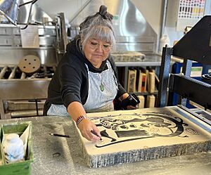 Image of Melanie A Yazzie working on a lithography stone