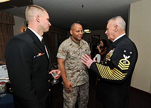 US Navy 100401-N-2013O-001 Chief Explosive Ordnance Disposal Technician Daniel Martin, from Houston, and Gunnery Sgt. Tony Smith, from Columbus, Ohio, chat with Master Chief Boatswain's Mate (SEAL) (Ret.) Rudy Boesch during a C