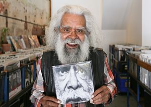 Charles smiling while holding a record