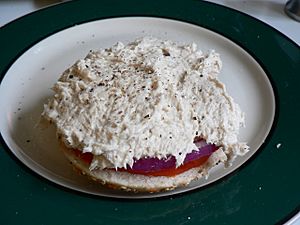 Whitefish salad on a bagel with onion and tomato