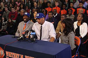20131115 Jahlil Okafor with his father and aunt during verbal commitment wearing hats