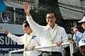Sam Rainsy and Kem Sokha wave to protesters