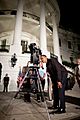 Barack Obama looks through a telescope