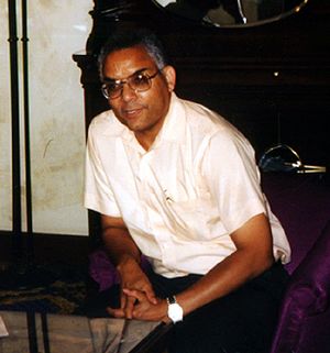 Photo of Raymond L. Johnson wearing glasses, a watch and a light-colored shirt