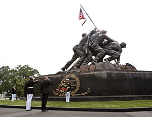 Honorary Marine Daran Wankum, third from left, salutes during a wreath laying ceremony at the Marine Corps War Memorial in Arlington, Va, June 13, 2013 130613-M-KS211-013