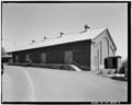 Oblique view of southwest front and southeast end; view to north, 90mm lens. - Benicia Arsenal, Powder Magazine No. 5, Junction of Interstate Highways 680 and 780, Benicia, HABS CAL,48-BENI,4-O-9
