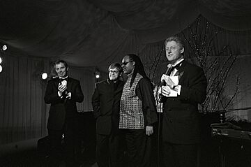 President Bill Clinton and Prime Minister Tony Blair are joined on stage by Elton John and Stevie Wonder