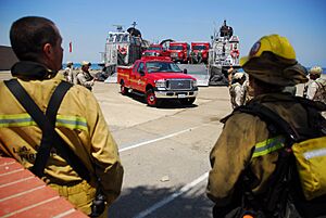 US Navy 070511-N-4774B-178 Sailors assigned to Assault Craft Unit (ACU) 5 assist Los Angeles County Fire Department in unloading their firefighting equipment from a Landing Craft Air Cushion (LCAC) on Catalina Island