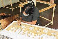Woman with brush painting batik Sri Lanka