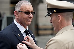 150501-N-OT964-160 - Robert Irvine being made an honorary U.S. Navy chief petty officer