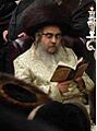 Grand Rabbi Aaron Teitelbaum, Satmar Rebbe, in synagogue, on Hanukkah, in Kiryas Joel, New York State