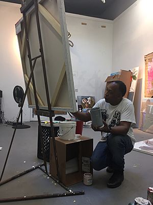 Henry Taylor painting in studio.JPG