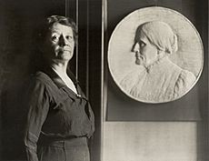Leila Usher with bas-relief of Susan B. Anthony