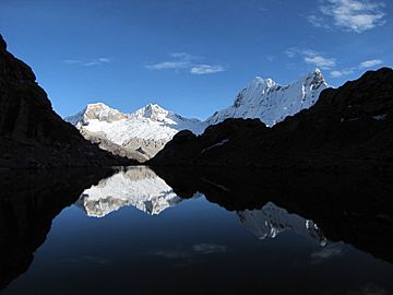 Pisco and Chacraraju reflection at Yanapaccha base camp (6020836415).jpg