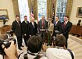 President George W. Bush poses for photos in the Oval Office with members of the National Capital Area Council of the Boy Scouts of America