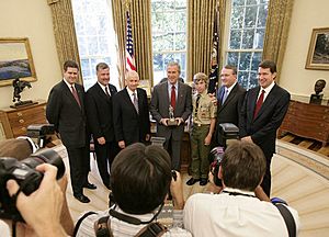 President George W. Bush poses for photos in the Oval Office with members of the National Capital Area Council of the Boy Scouts of America