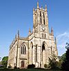 An elaborate Gothic Revival church with a west tower and crosketed pinnacles