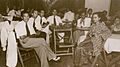 Tun Dr Mahathir Mohamad (most left) and Tun Dr Siti Hasmah (far right) sitting around the table with their classmates at King Edward VII College of Medicine, Singapore