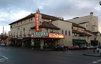 Photograph of a tile-roofed building with a large marquee on an urban street corner