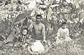 Native Hawaiian man pounding taro into poi with two children by his sides., c. 1890s