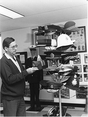Ross Chippindall, Curator of Queensland Police Museum between 1979 and 1985, examines a selection of police headgear