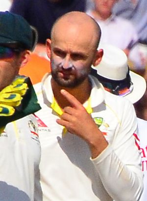 Australia captain wicketkeeper Tim Paine and spin bowler Nathan Lyon of Australia discuss tactics as Jofra Archer walks to the wicket on Day 4 of the 3rd Test of the 2019 Ashes at Headingley (48630967226) (Lyon cropped)