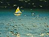 A flock of Canadian geese flying in front of a yellow sailboat with a yellow and white sail on a blue lake