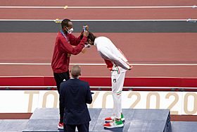 Mutaz Barshim presents high jump co-winner Gianmarco Tamberi with his gold medal at the Tokyo 2020 Olympic Games