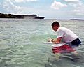 US Navy 030420-N-9236M-025 Chief Electronics Technician Geoffrey Ormston is immersed in the waters of Apra Harbor, Guam by Chaplain Richard Inman during a baptismal ceremony on Easter Sunday