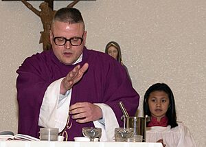 US Navy 060301-N-5686B-001 USS Kitty Hawk (CV 63), Chaplain, Lt. Matthias Rendon blesses ashes, during an Ash Wednesday service held on board Commander Fleet Activities Yokosuka
